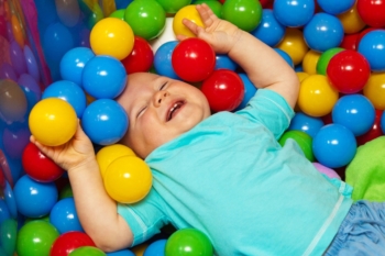 Kid playing in ball pit