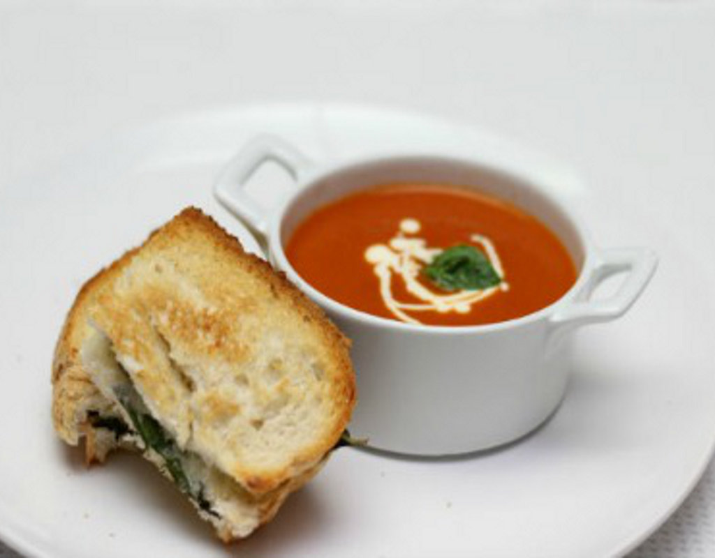 Homemade tomato soup with basil and mozzarella grillers