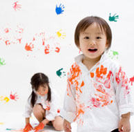 Kids with paint hands all over them