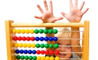 little boy behind abacus