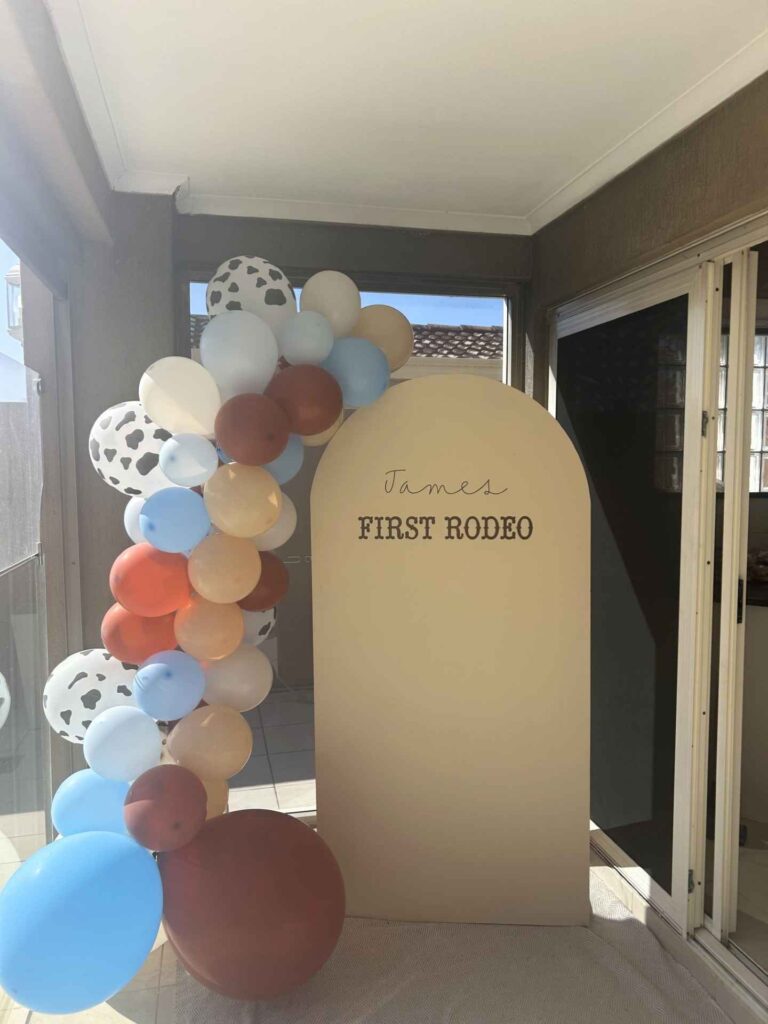 Custom balloon arch and sign that reads James First Roedo.