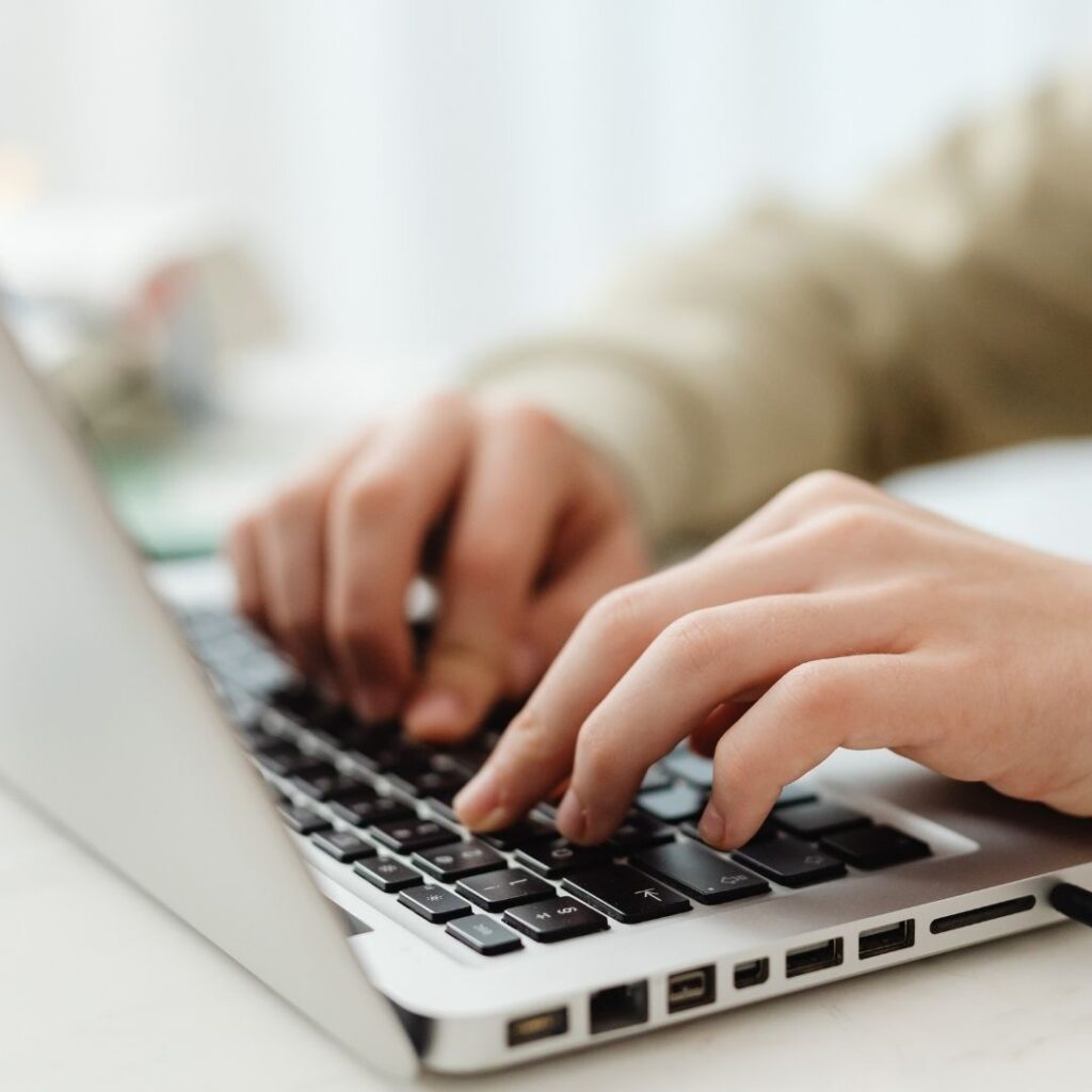 Hands typing on a laptop. 