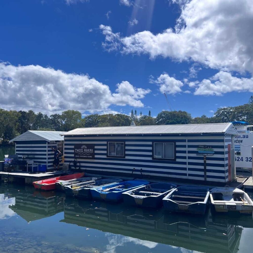 Small boats outside a Tweed Marina river shed.